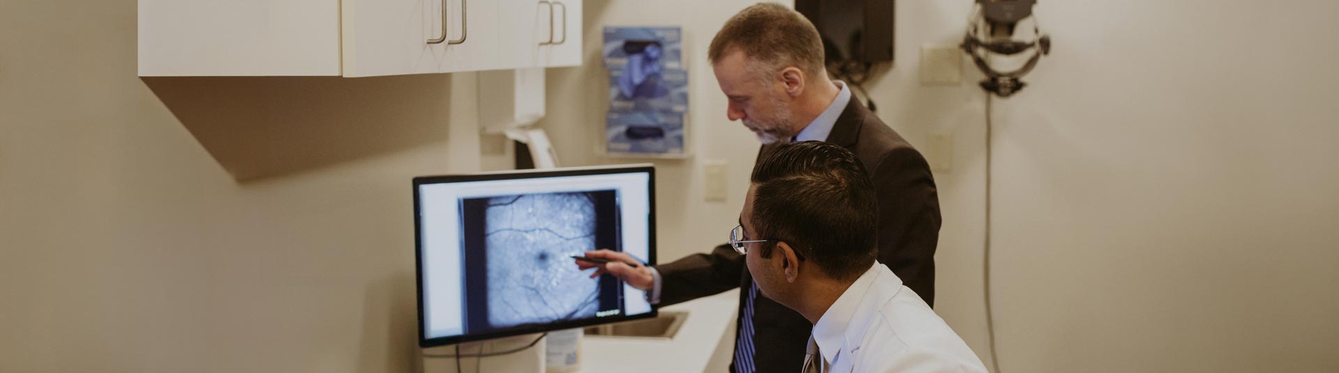 opthalmologists reviewing retinal scan on computer